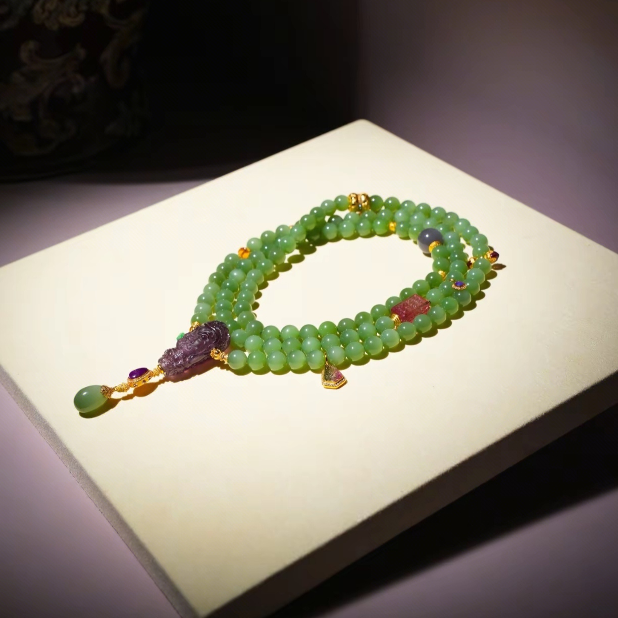 Smoky purple jade landscape tablet pendant with jade bracelets display